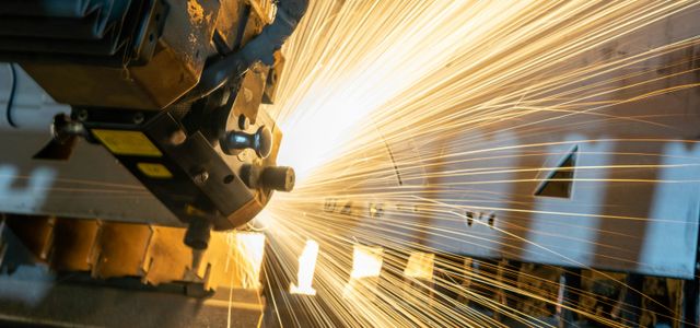 man in blue jacket standing beside brown wooden post