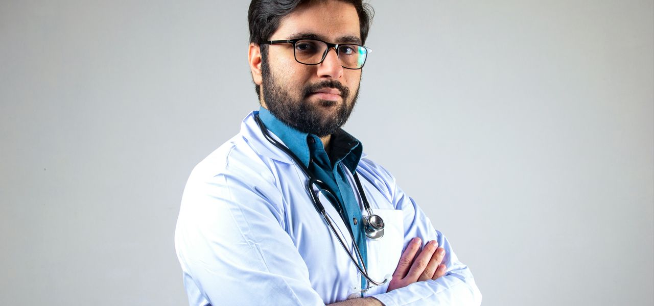 man in white dress shirt wearing black framed eyeglasses