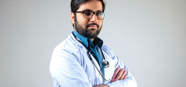 man in white dress shirt wearing black framed eyeglasses