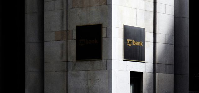 man standing near road beside building during daytime