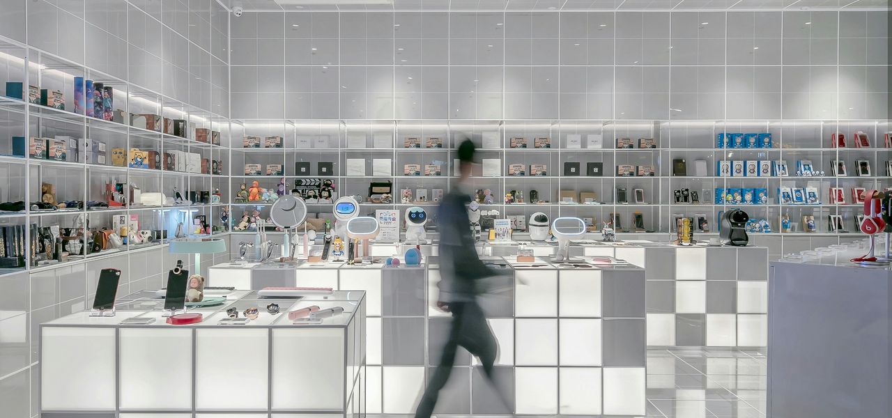 man walking beside white cube decoration