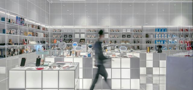 man walking beside white cube decoration