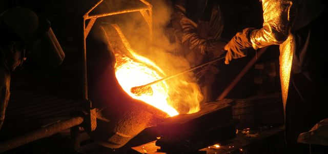 man wearing gloves and mask holding iron