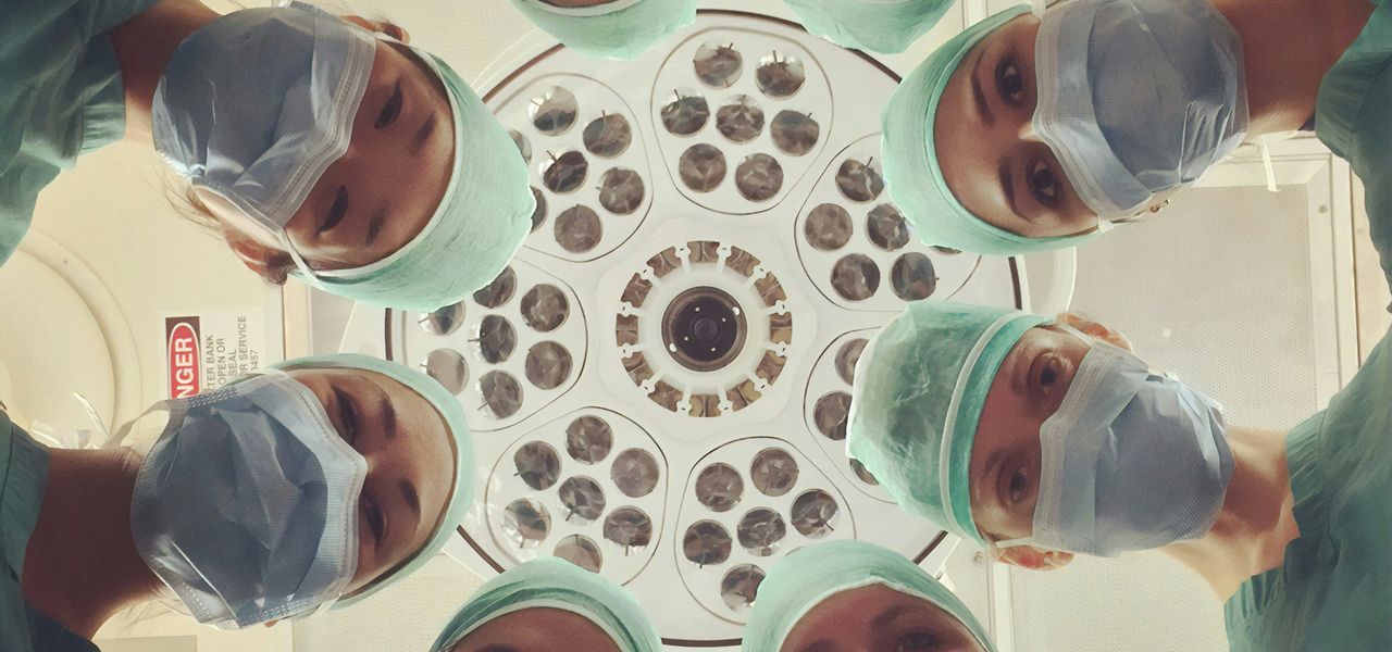 people in white shirt holding clear drinking glasses