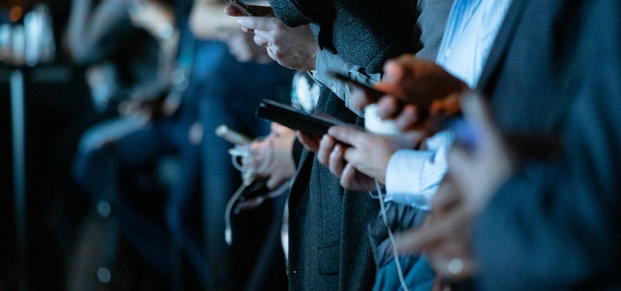 people using phone while standing