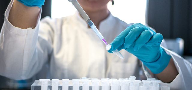 person holding orange and white toothbrush
