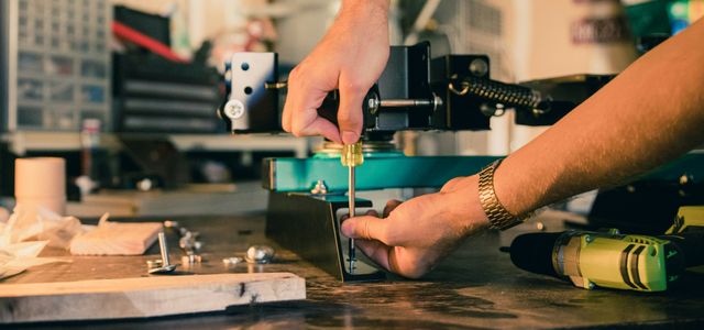 person holding screwdriver