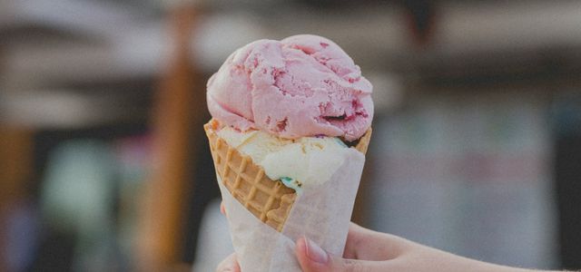 person holding strawberry ice cream