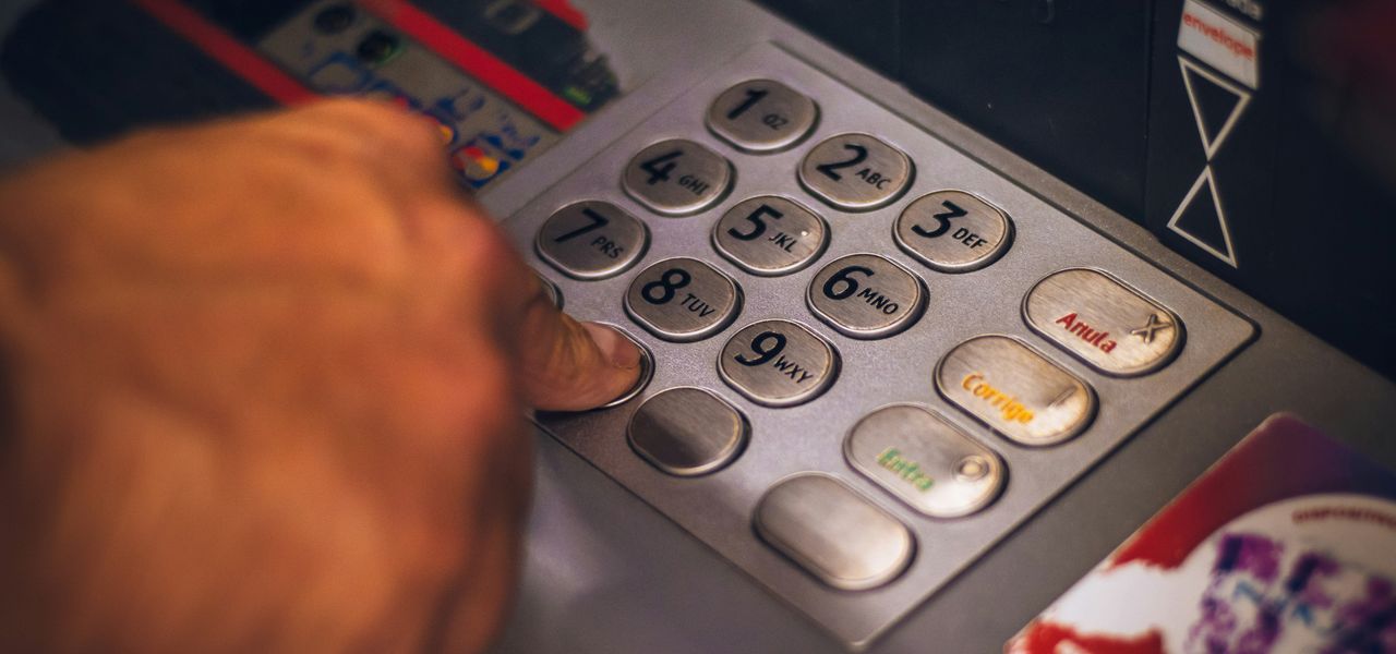 person holding white and red card