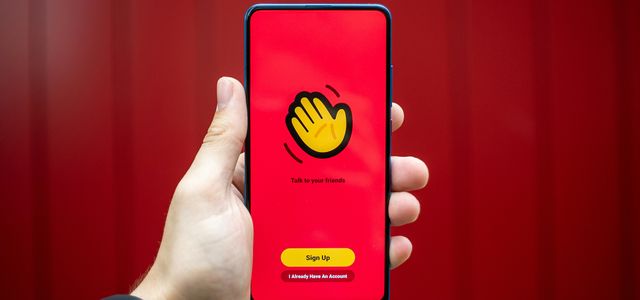 person holding yellow and black iphone case