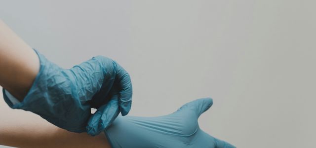 person in blue gloves and blue denim jeans