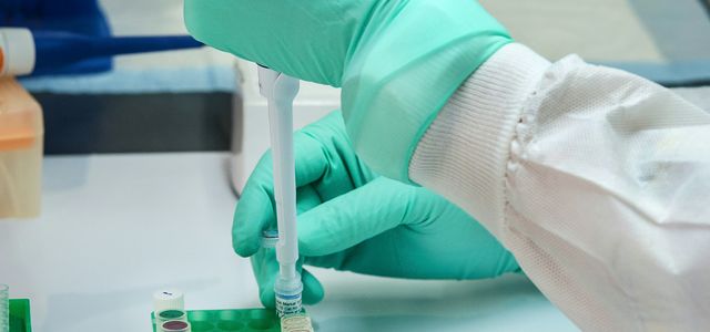 person in white long sleeve shirt holding green and white labeled can
