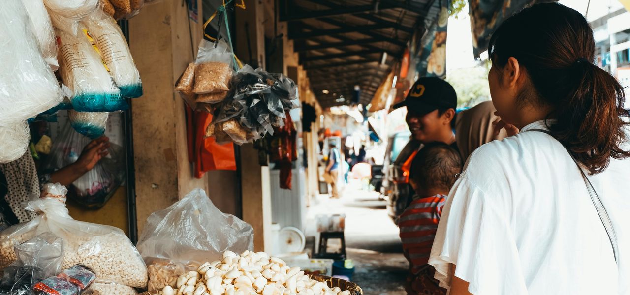 person in white T-shirt beside store
