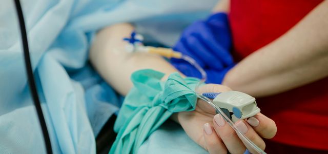 person lying on bed and another person standing
