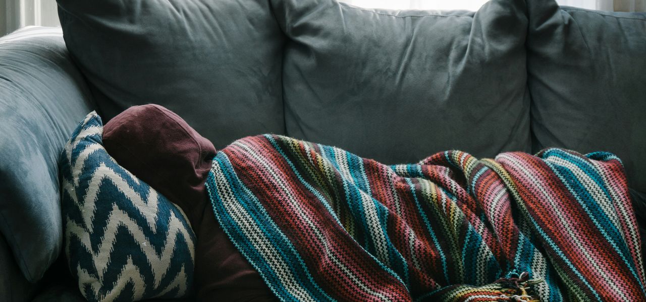 person lying on gray sofa