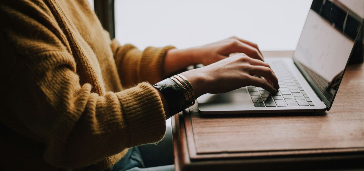 person sitting front of laptop