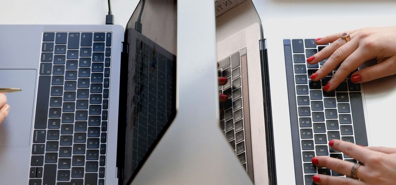 person typing on silver laptop computer