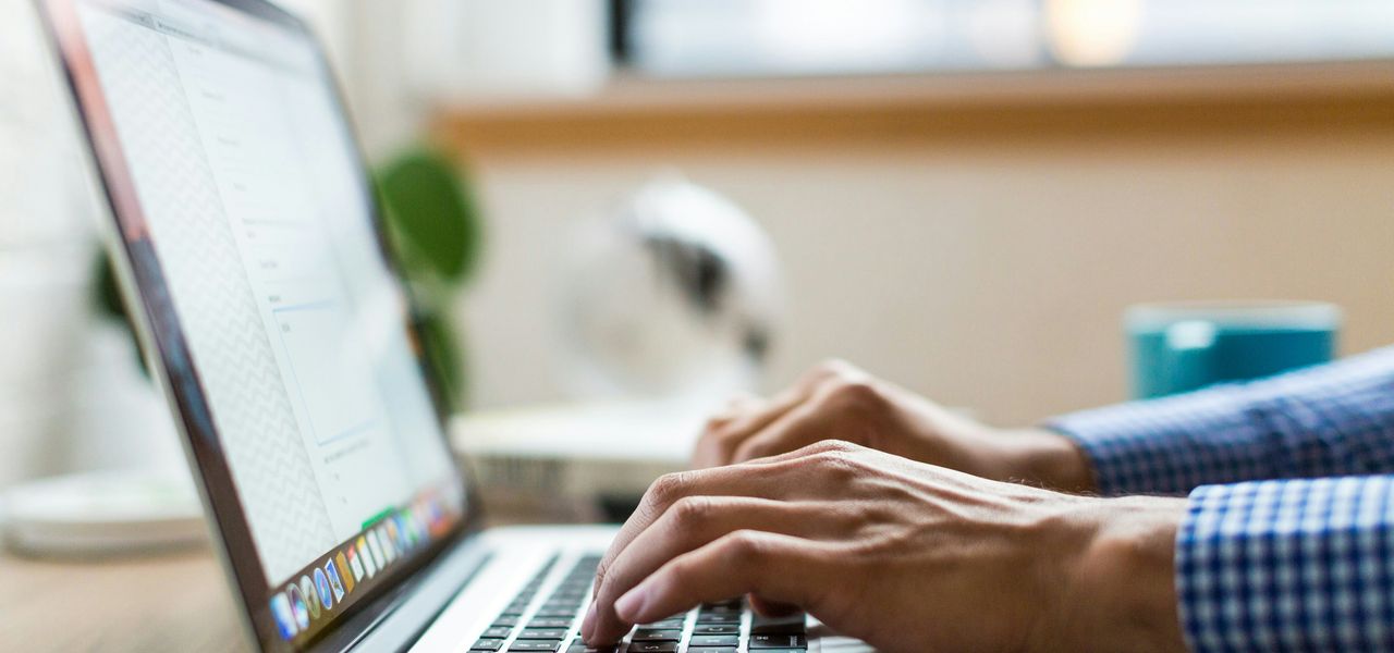 person typing on silver MacBook