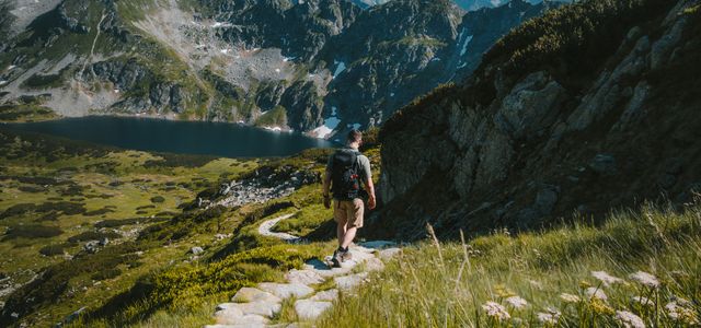 person walking towards mountain during daytime