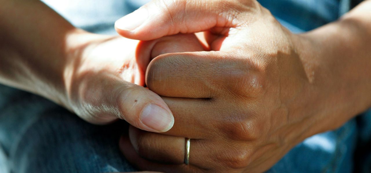 person wearing gold wedding band
