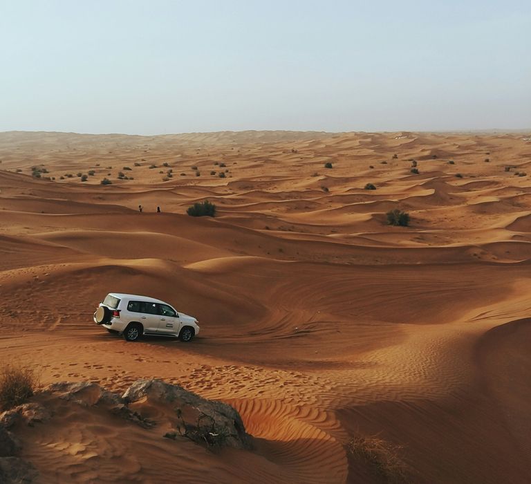 photography of white SUV on desert