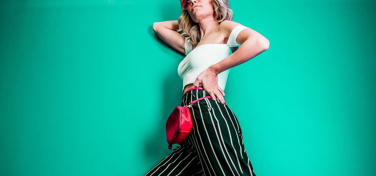 posing woman in white sleeveless top