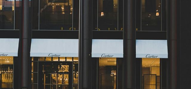 red coupe infront of cartier shop