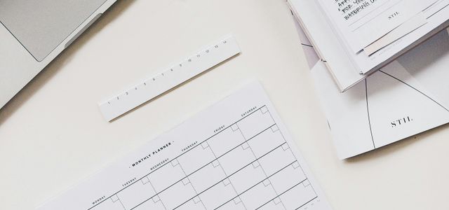 silver laptop computer near notebook