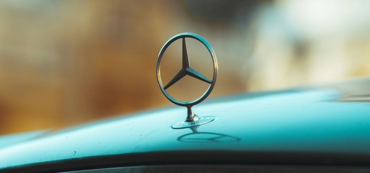 silver mercedes benz car with black and brown heart shaped emblem