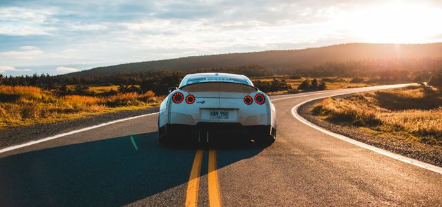silver sports coupe on asphalt road