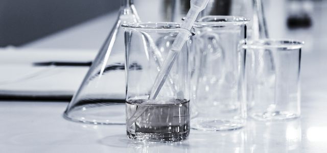 three clear beakers placed on tabletop