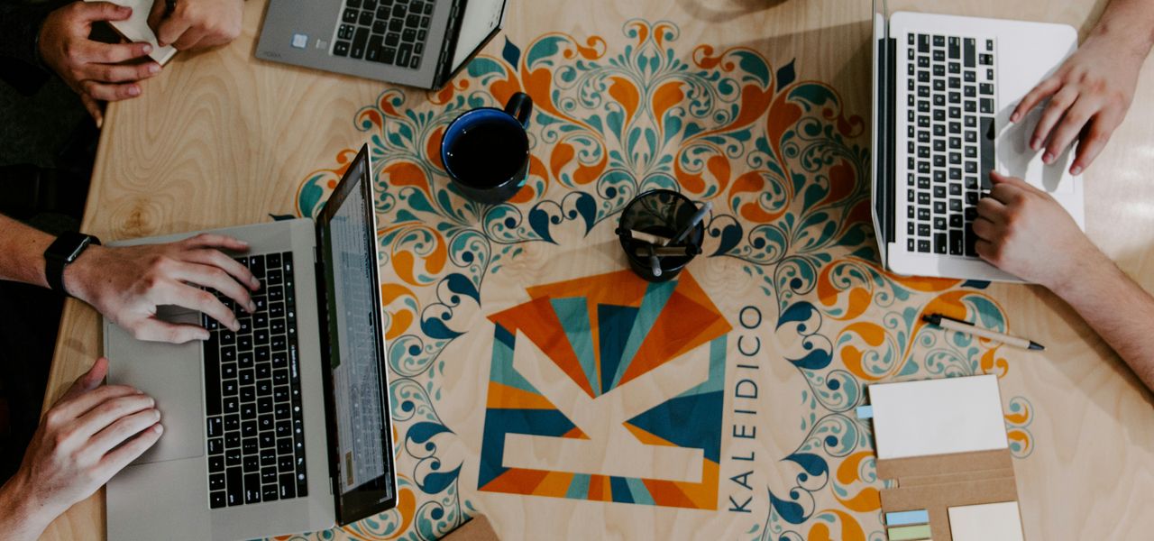 three person using laptops