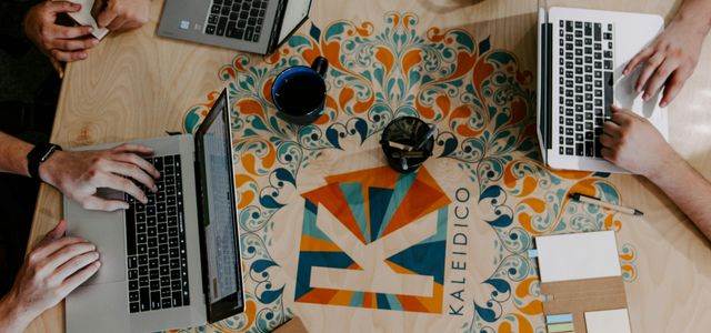 three person using laptops