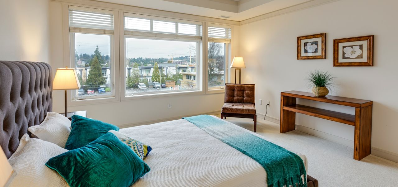 two green and white pillows on empty bed