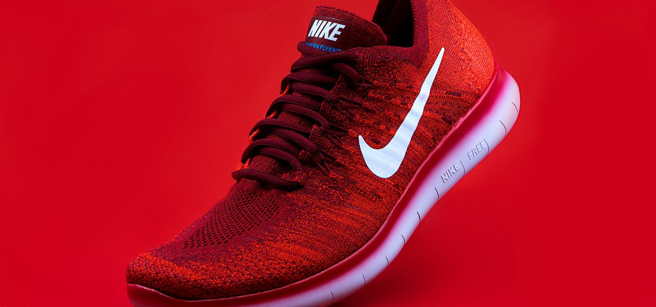 unpaired red Nike sneaker