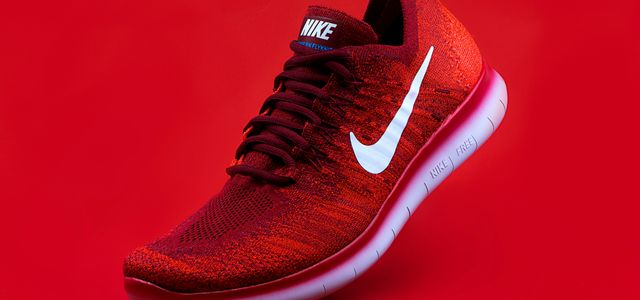 unpaired red Nike sneaker