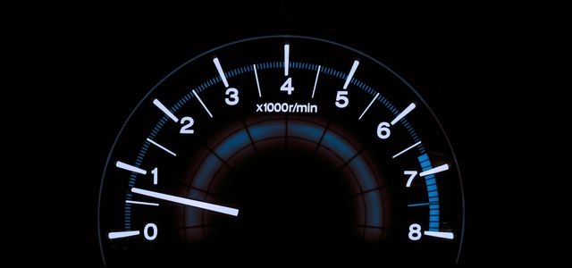 white and blue analog tachometer gauge