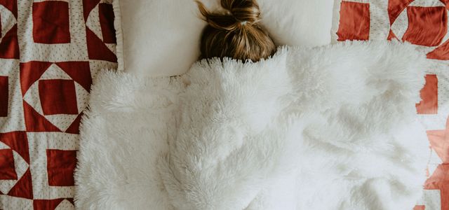 white fur textile on red and white textile