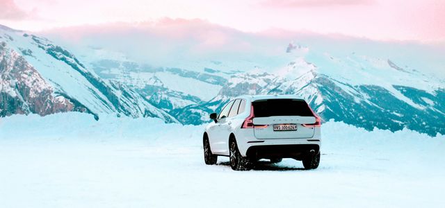 white suv on snow covered field during daytime