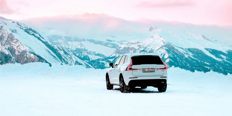 white suv on snow covered field during daytime