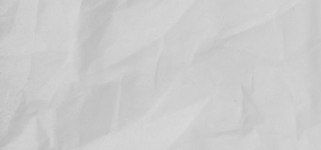 white textile on brown wooden table