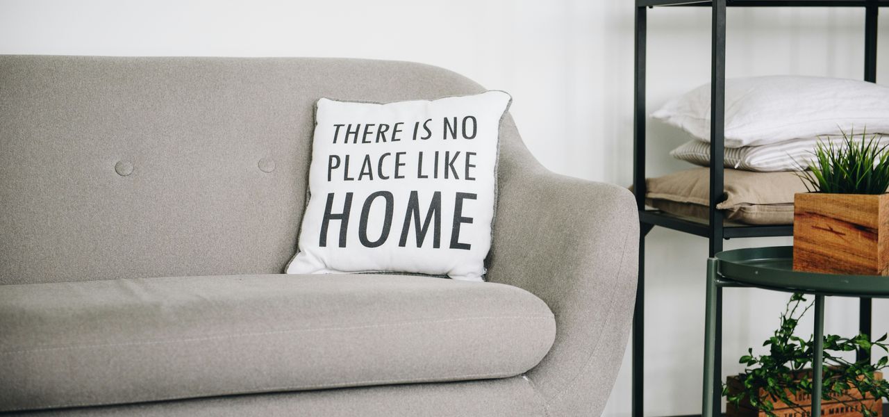 white throw pillow on gray sofa