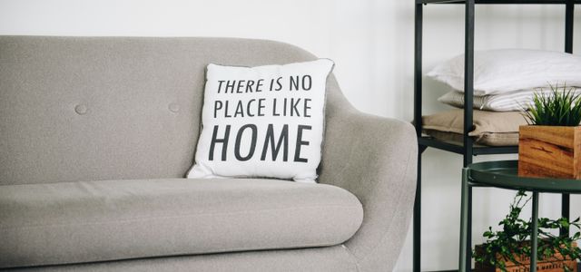 white throw pillow on gray sofa