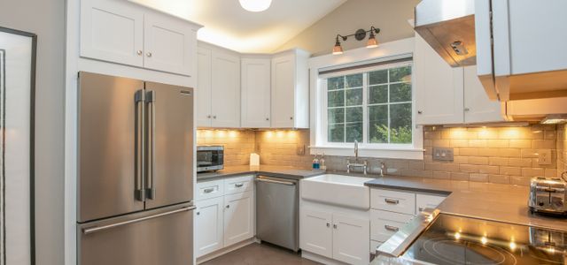white wooden kitchen cabinet and white pendant lamp