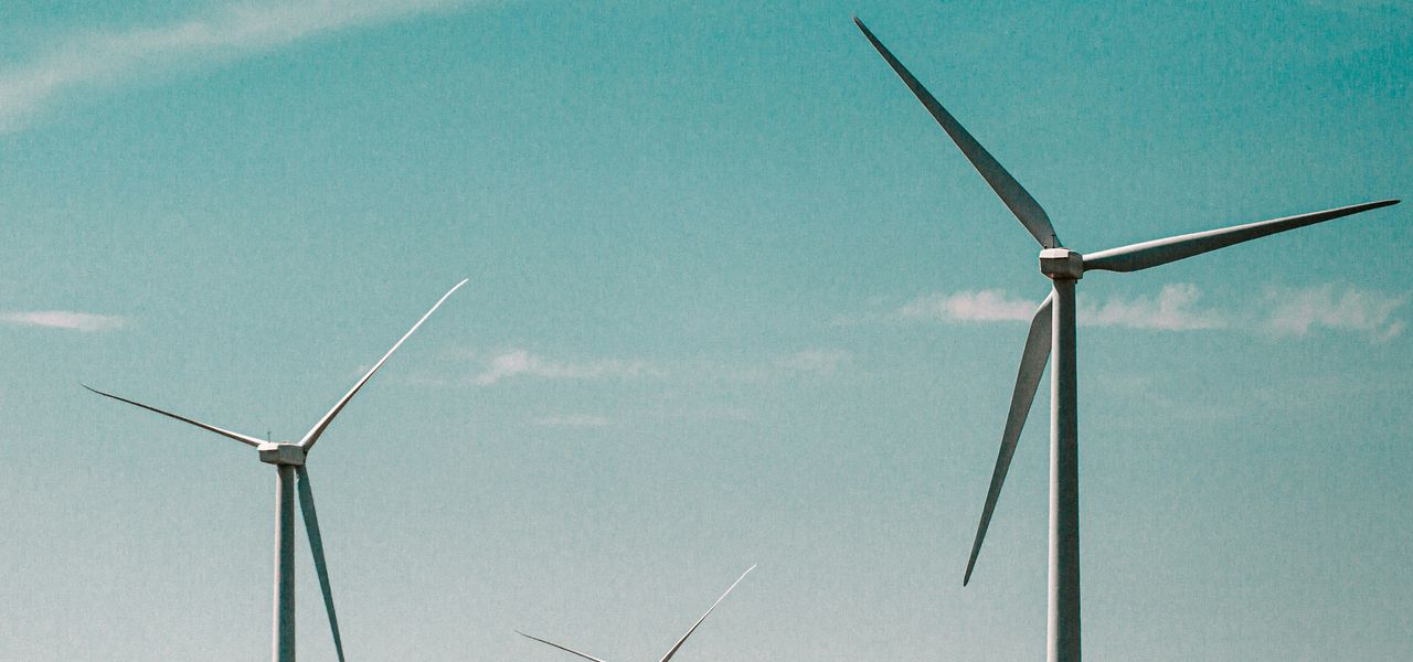 wind turbines under blue sky during daytime