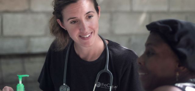 woman in black crew neck shirt wearing blue earbuds