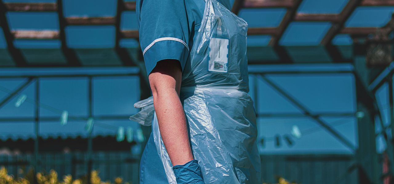 woman in blue and white polo shirt standing on yellow flower field during daytime