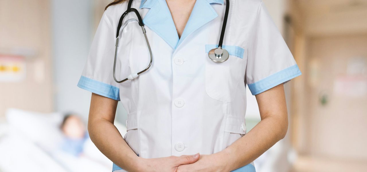 woman in white button up shirt and blue stethoscope