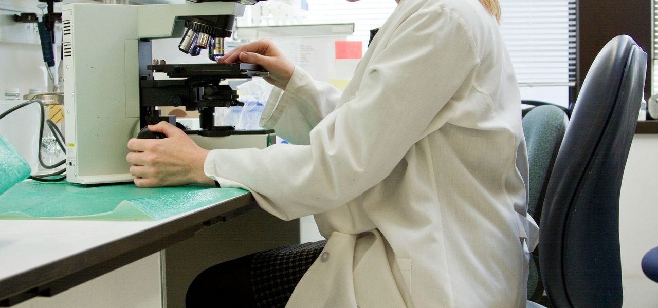 woman in white robe sitting on black office rolling chair