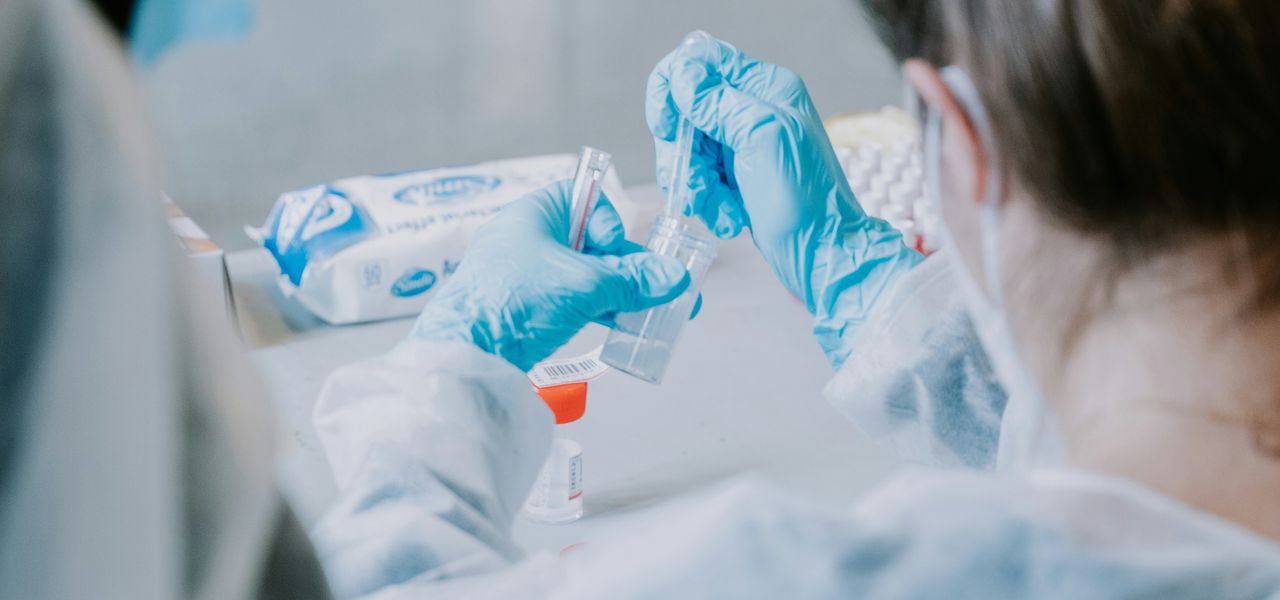 woman in white shirt holding blue and white plastic toy